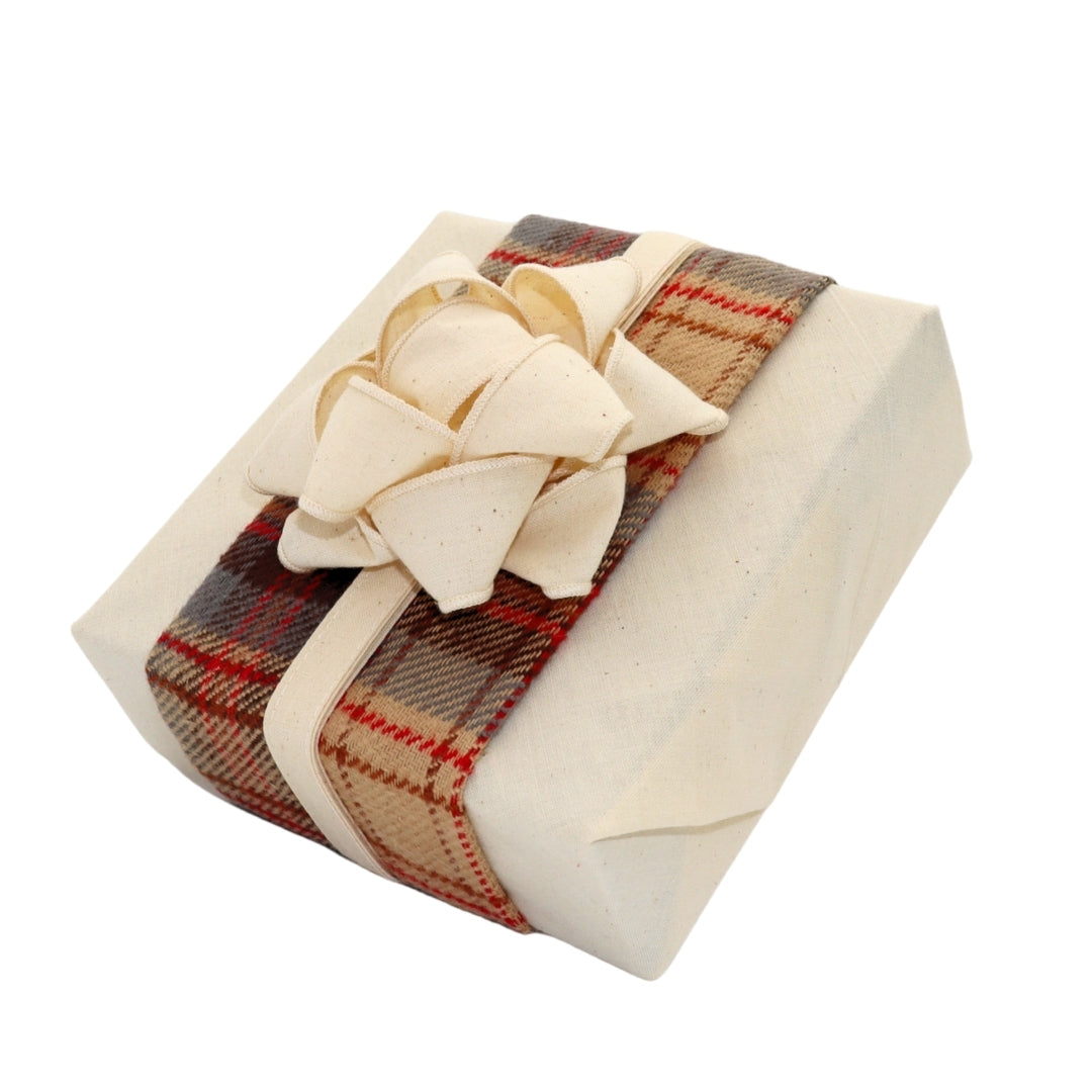 Reusable gift wrapping Vice-Versaᴷᴵᵀ - Red, beige, and gray tartan wool headband on a cream Furoshiki and a cream cabbage