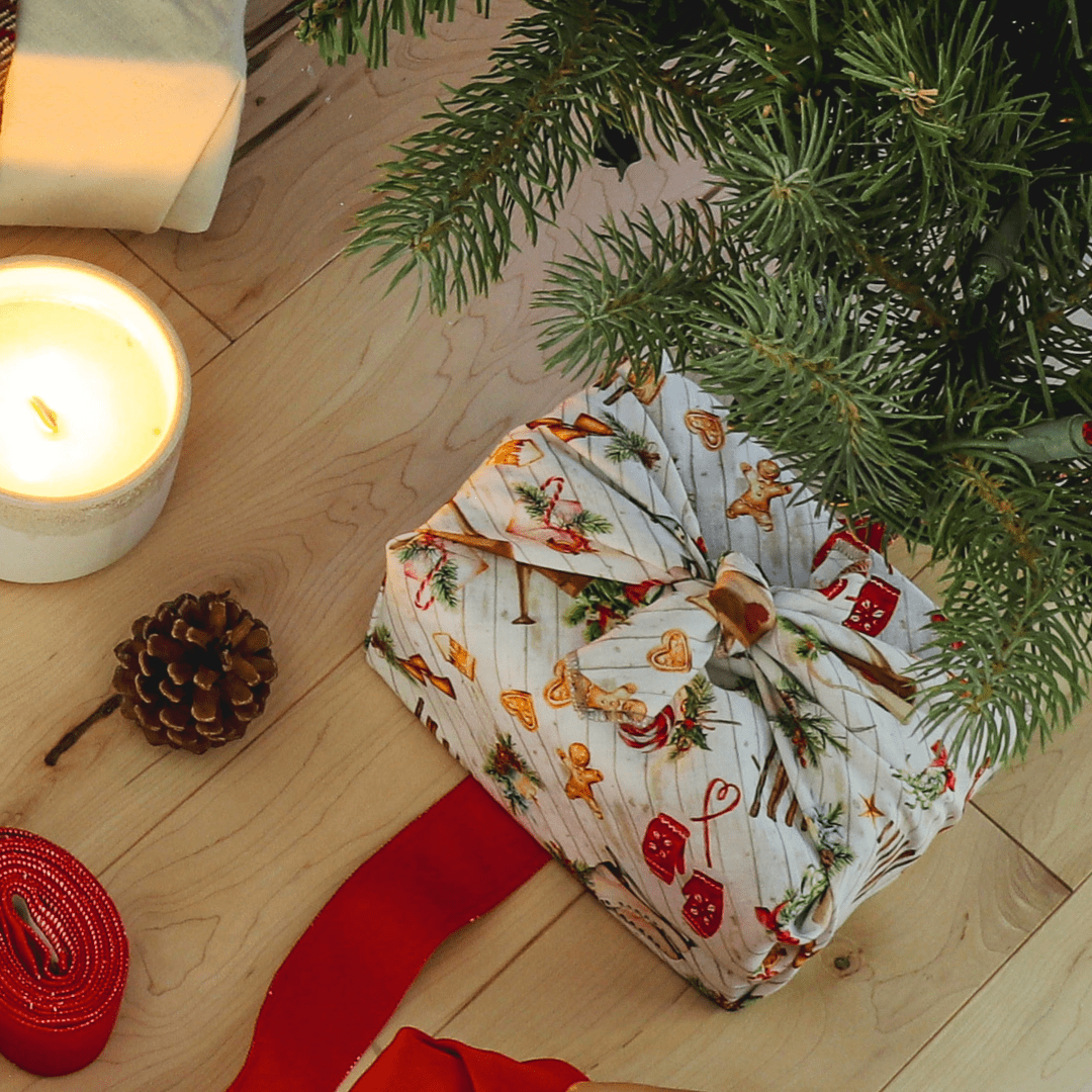 A package wrapped with blue and white furoshiki gift wrapping with the fabric tied in a knot at the top